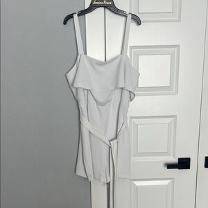 E This is a white ruffle romper, potentially by Express